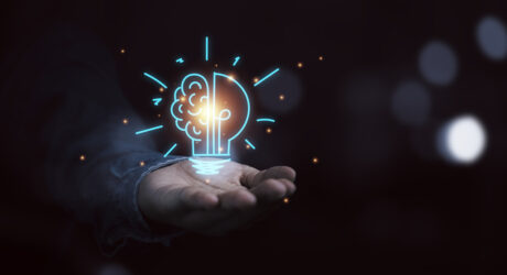 Hand holding drawing virtual lightbulb with brain on bokeh background for creative thinking idea and innovation concept.