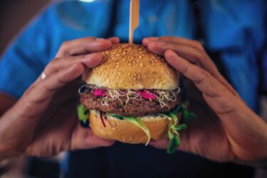 Veggie Burger Being Held