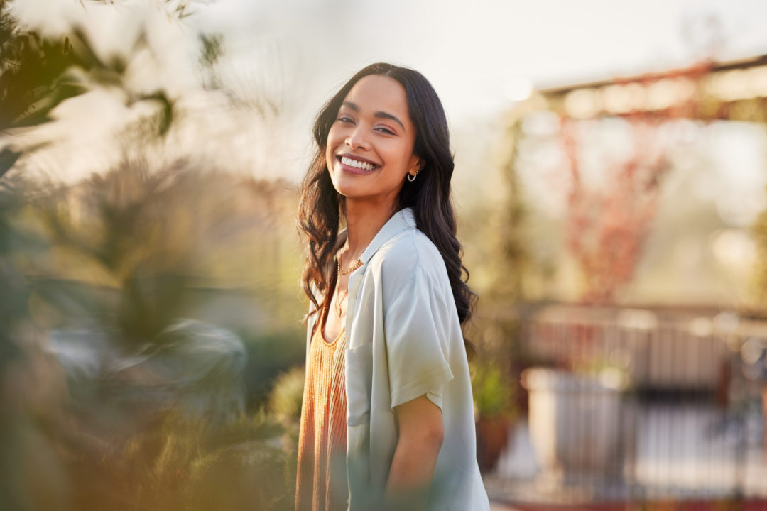 Mindful multiethnic woman enjoy morning ritual with fresh air.