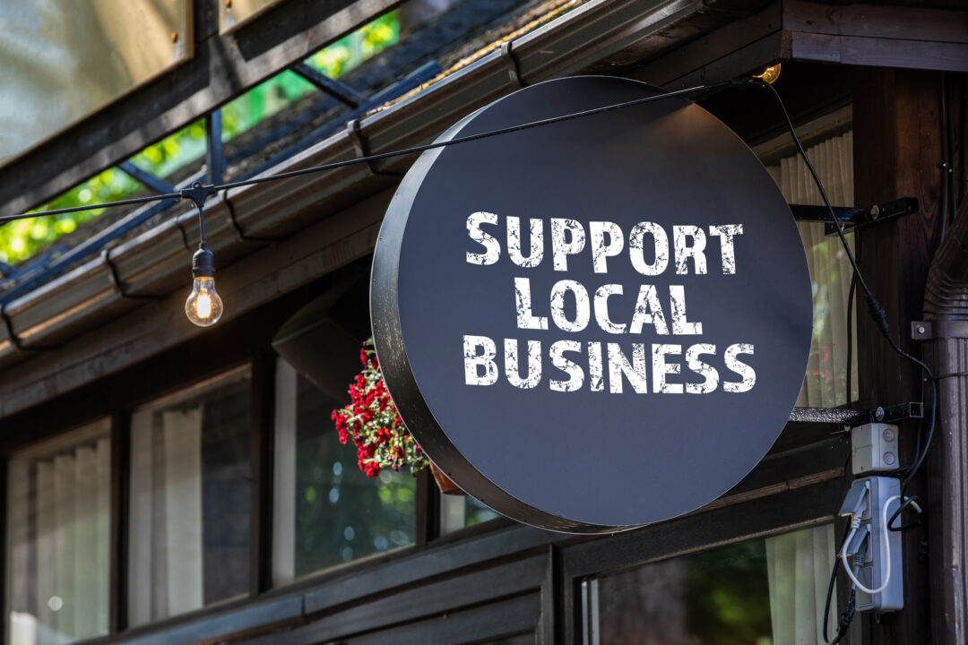 Support local business. Round, black sign wall.