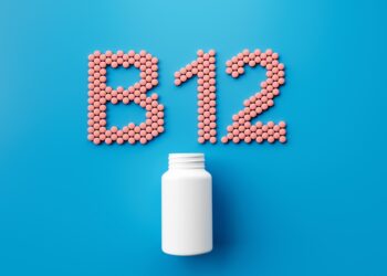 White Pill Bottle With B12 Text Made Of Rounded Vitamin B12 Tablets 3d