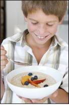 Boy holding bowl of cereal