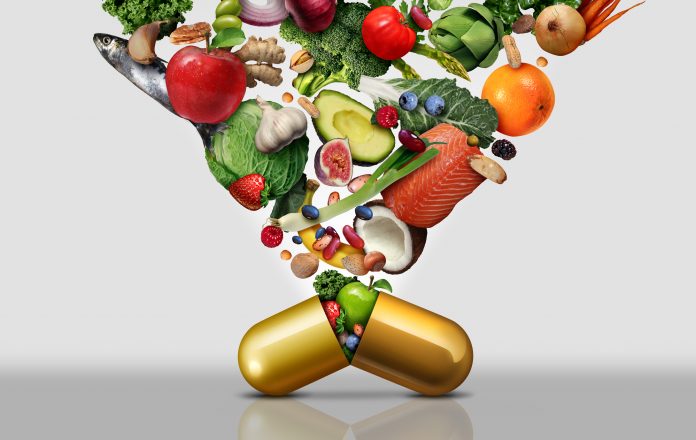 Vitamin dietary supplement as a capsule with fruit vegetables nuts and beans inside a nutrient pill as a natural medicine health treatment with 3D illustration elements.