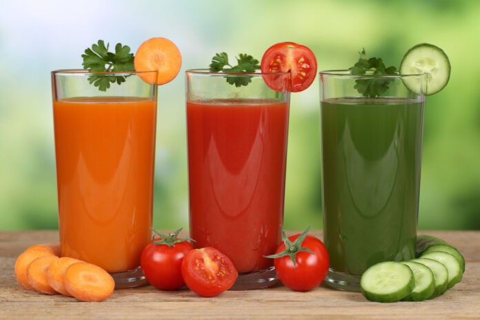 Fresh vegetable juice from carrots, tomatoes and cucumber