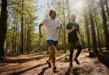 Men jogging in woods, fit and happy.