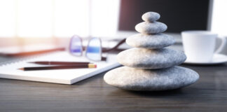 Stack of white pebbles on a workplace desktop - 3D illustration
