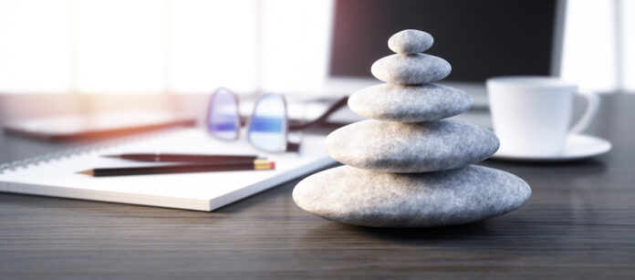 Stack of white pebbles on a workplace desktop - 3D illustration